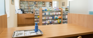 Pharmacy ear piercing aftercare supplies laid out on a clean consultation counter for a healing timeline guide