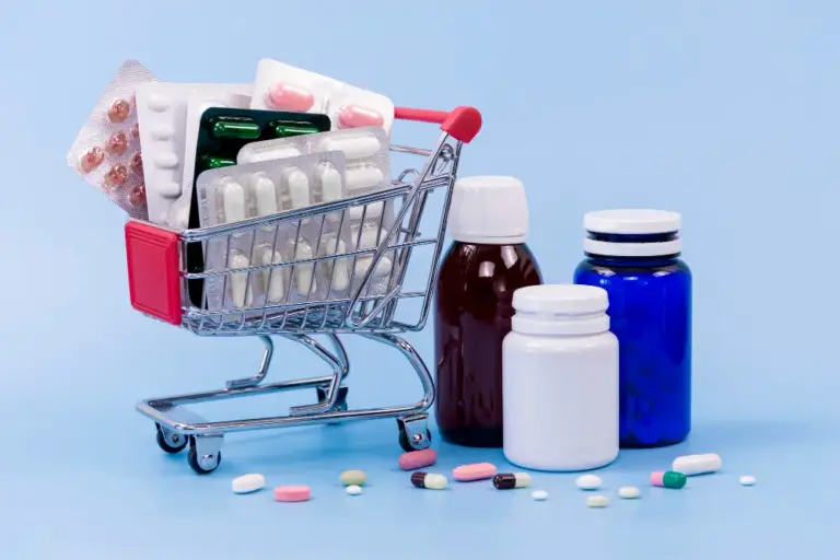 Blister packs of tablets and medicine bottles in a small shopping trolley